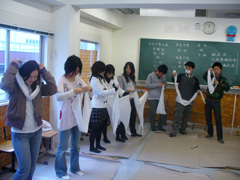 三角巾をたたむ学生